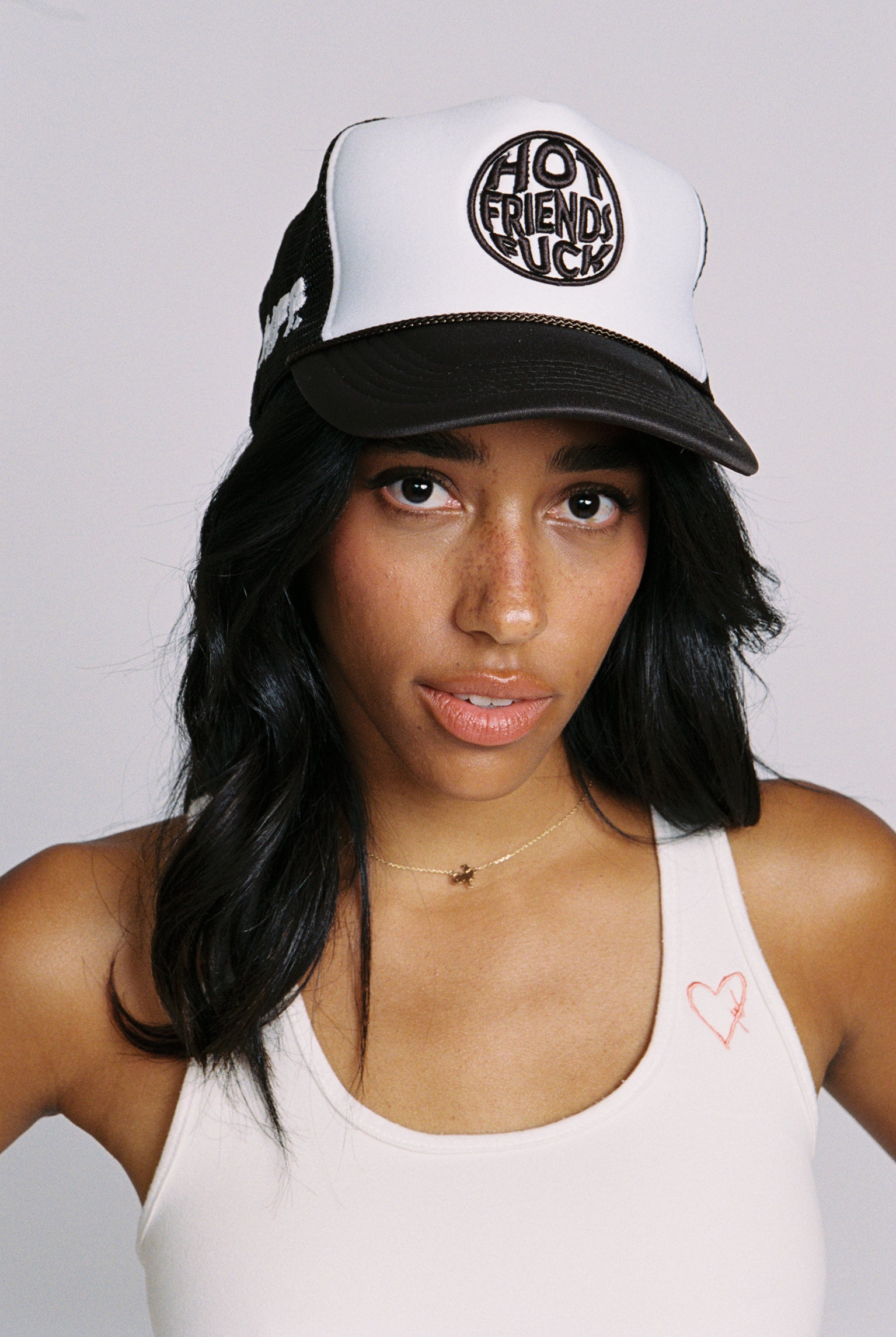 Maddie is wearing the Brown Hat with White and Brown Embroidery