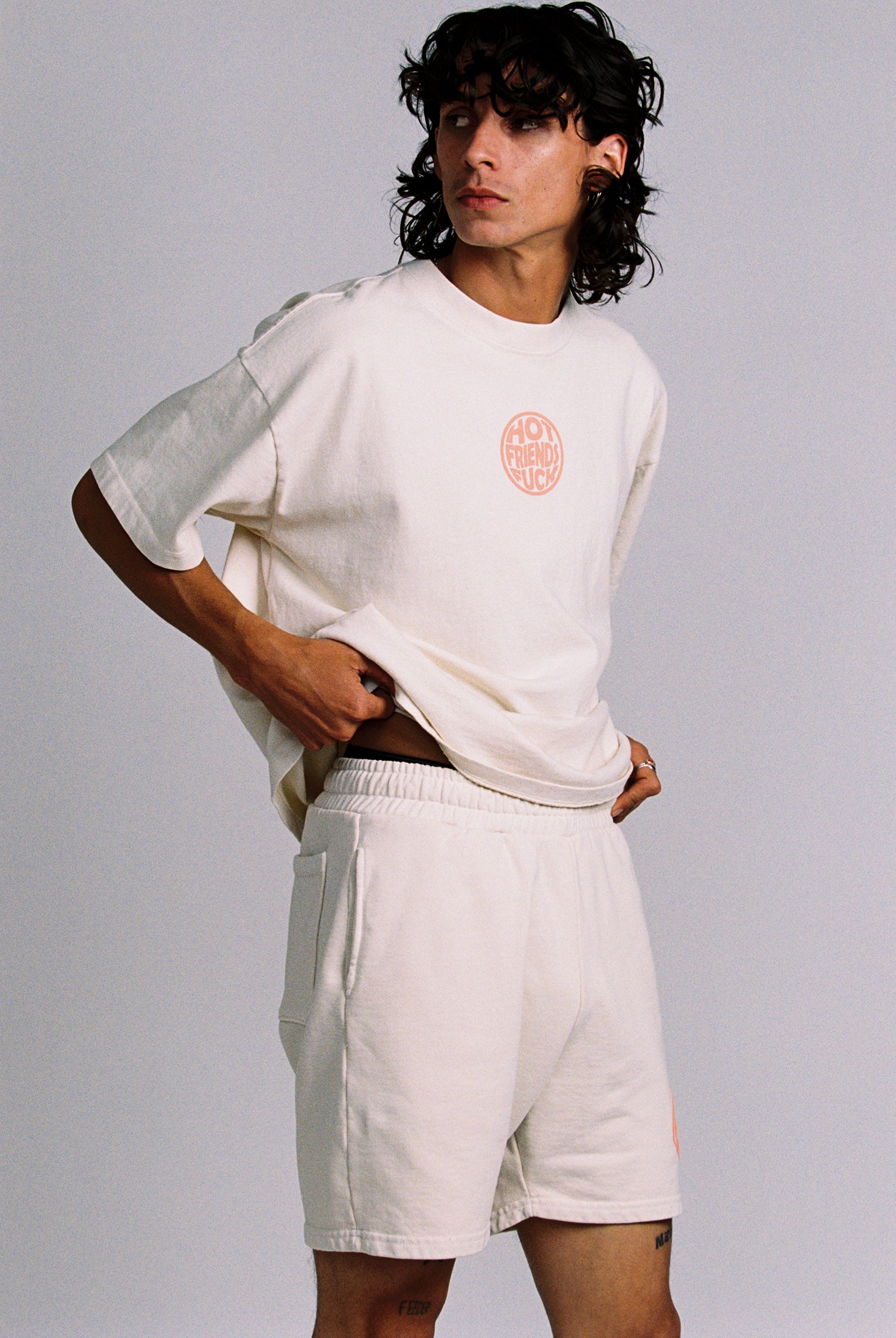 Donovan is wearing the Cream Shorts with Salmon Pink Puff Print
