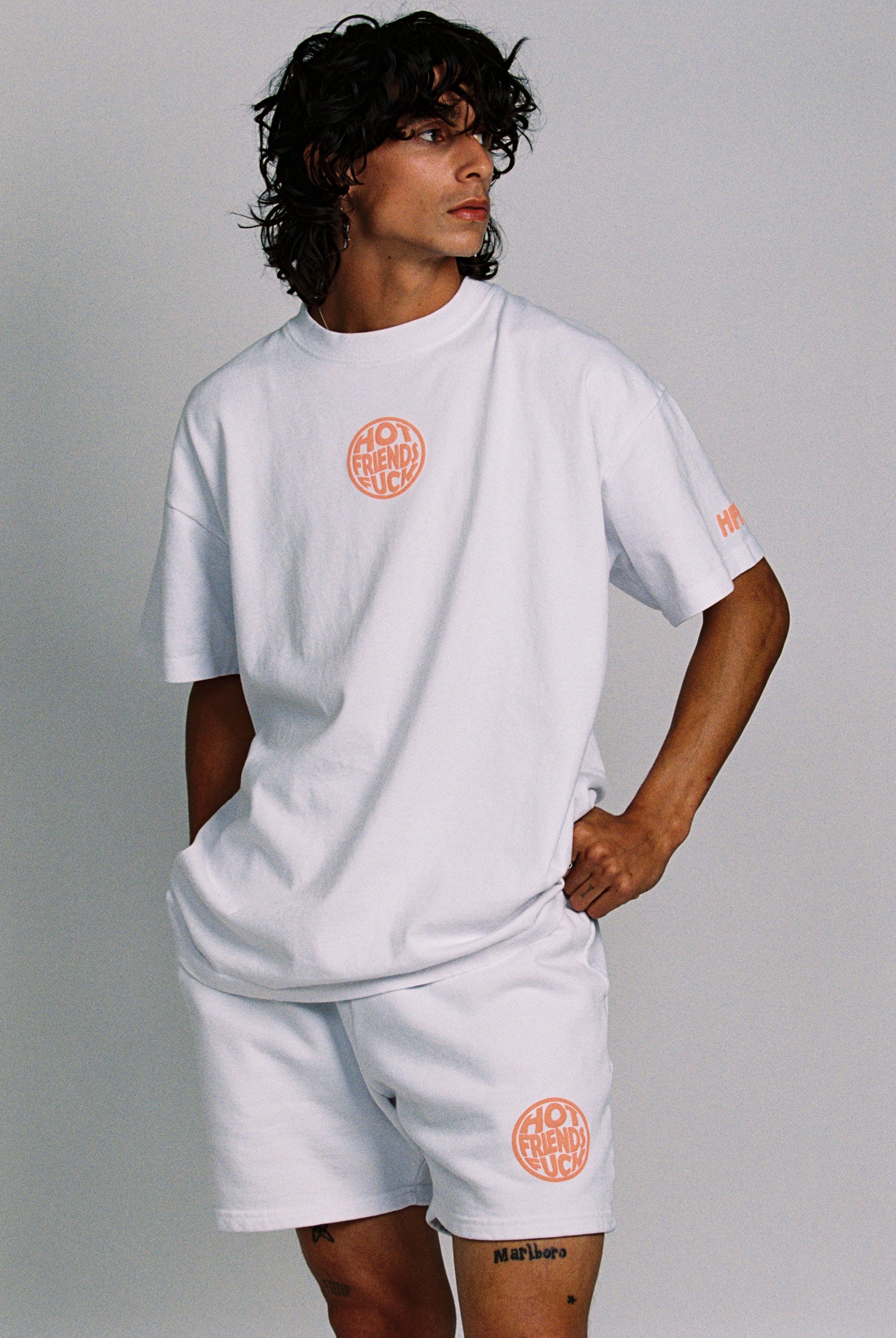 Donovan is wearing the White Shorts with Salmon Pink Puff Print