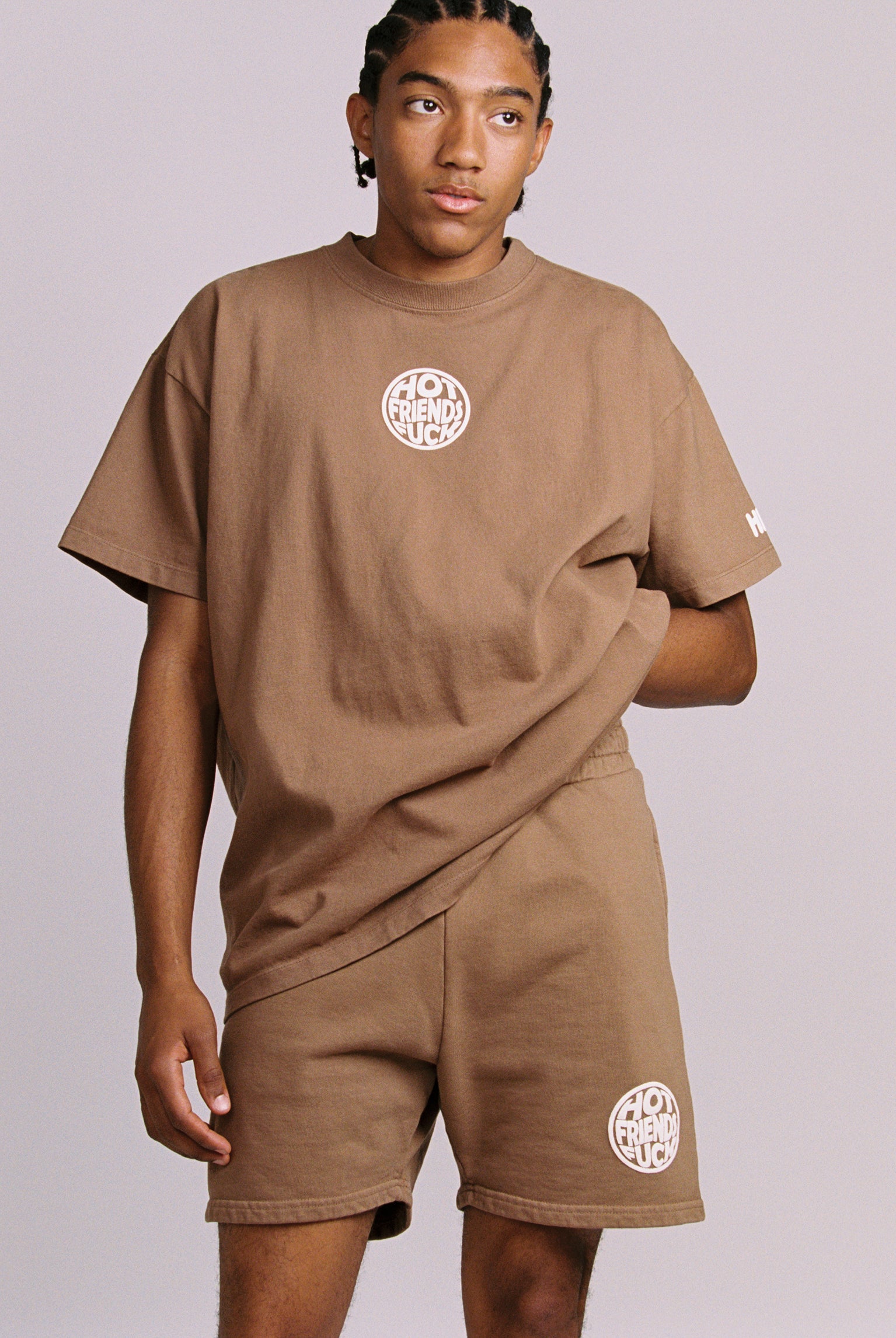 Hechan is wearing the Brown Shorts with White Puff Print