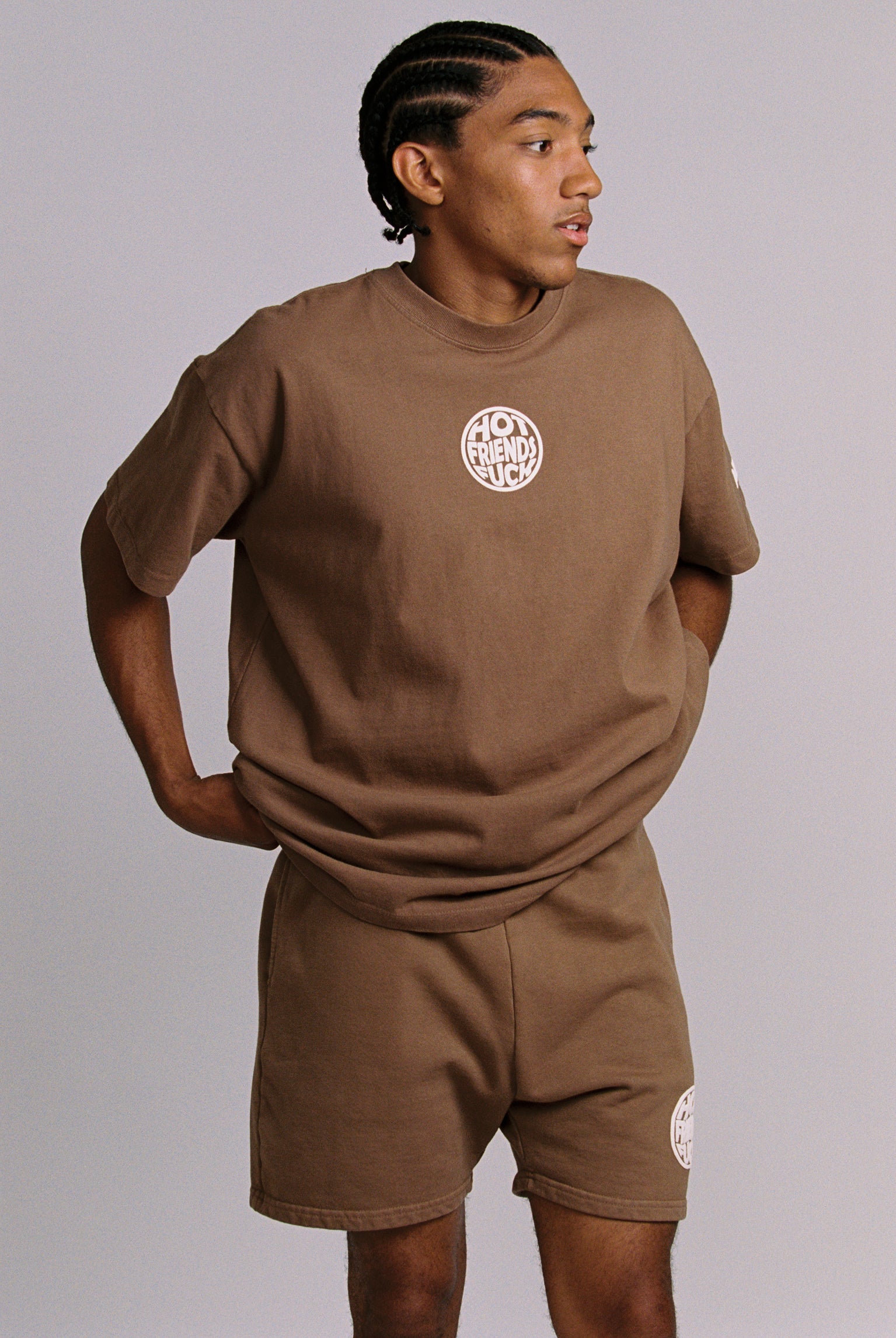 Hechan is wearing the Brown shirt with White Puff Print