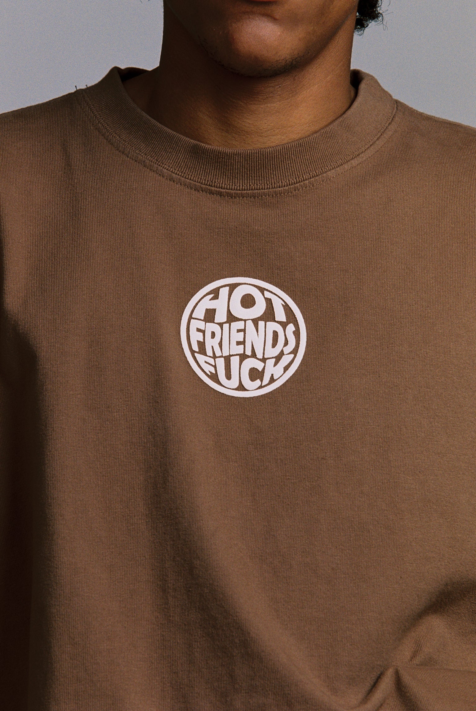 Hechan is wearing the Brown shirt with White Puff Print
