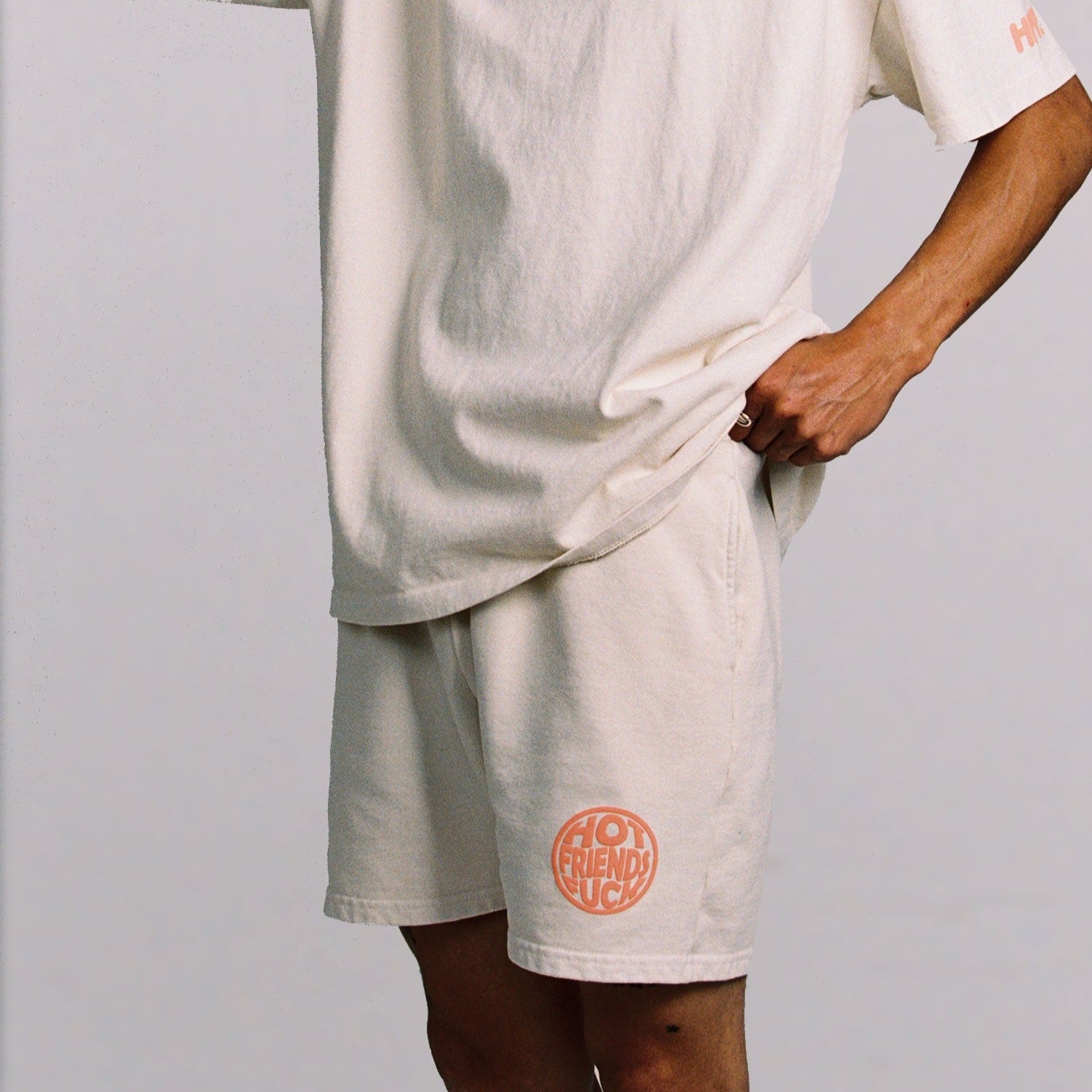 Donovan is wearing the Cream Shorts with Salmon Pink Puff Print.
